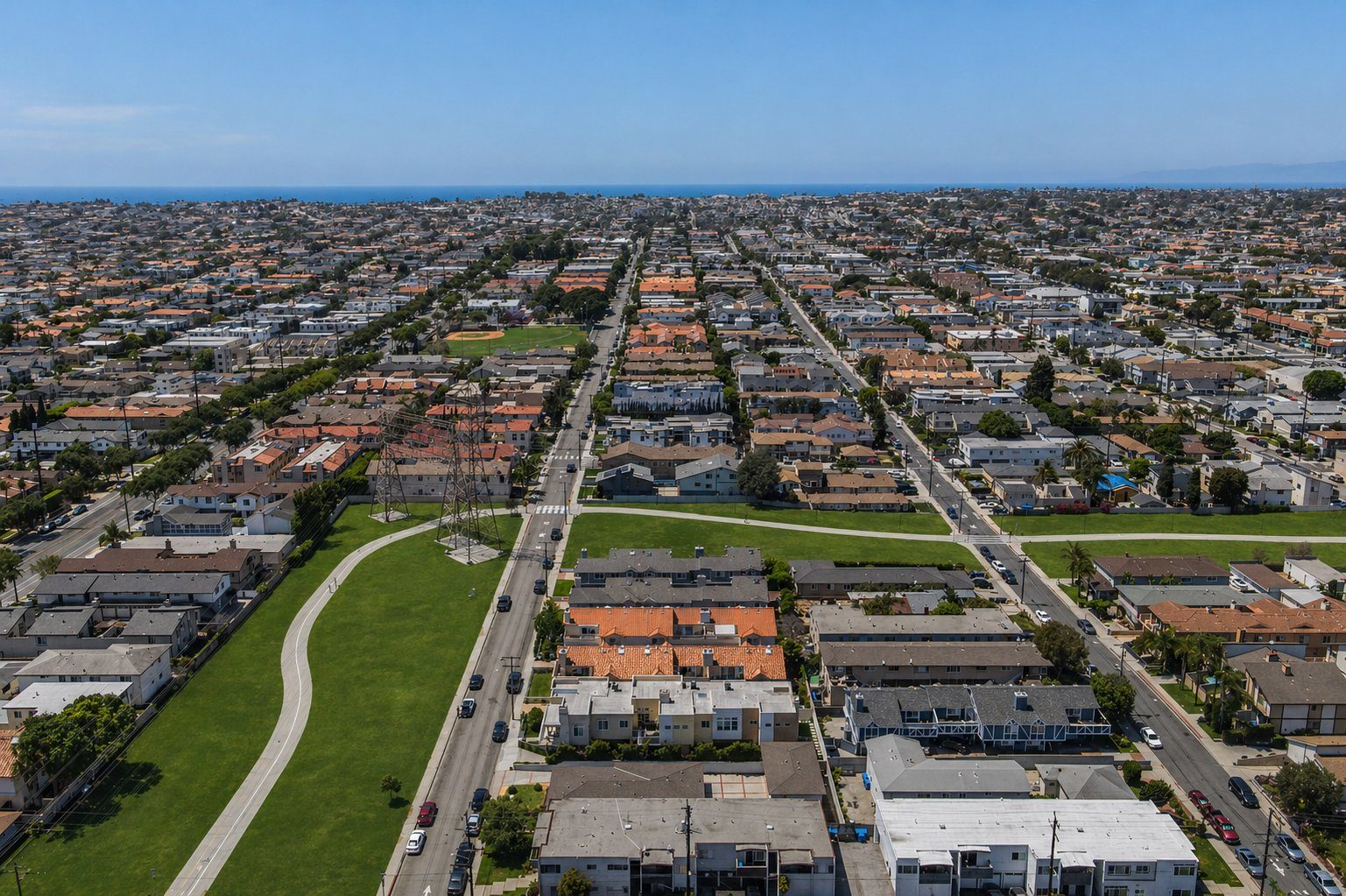 Aerial view showing the home directly across from the North Redondo Greenbelt with the Pacific Ocean in the distance
