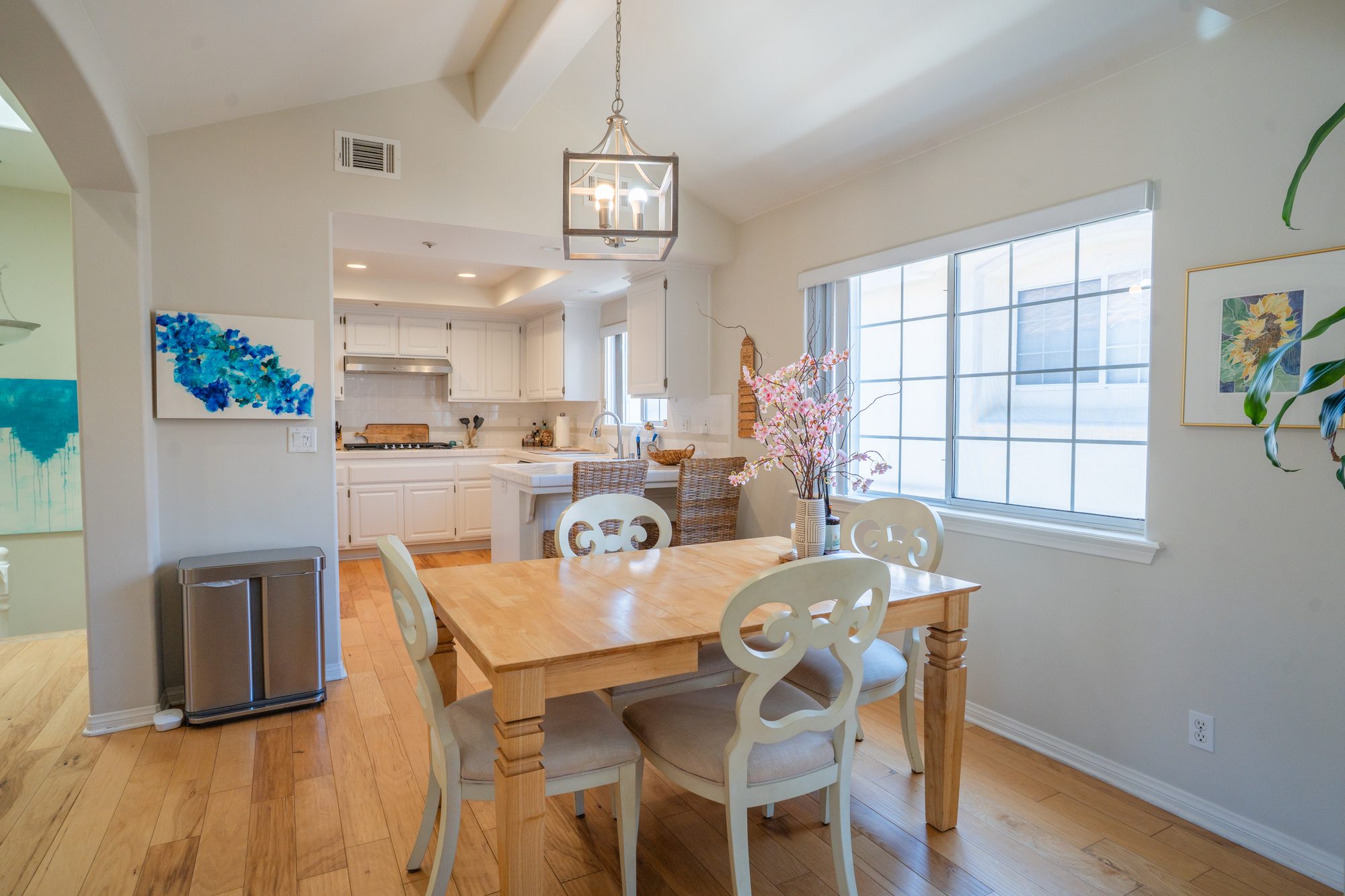 Living room alternate angle showing arched openings to the kitchen and dining