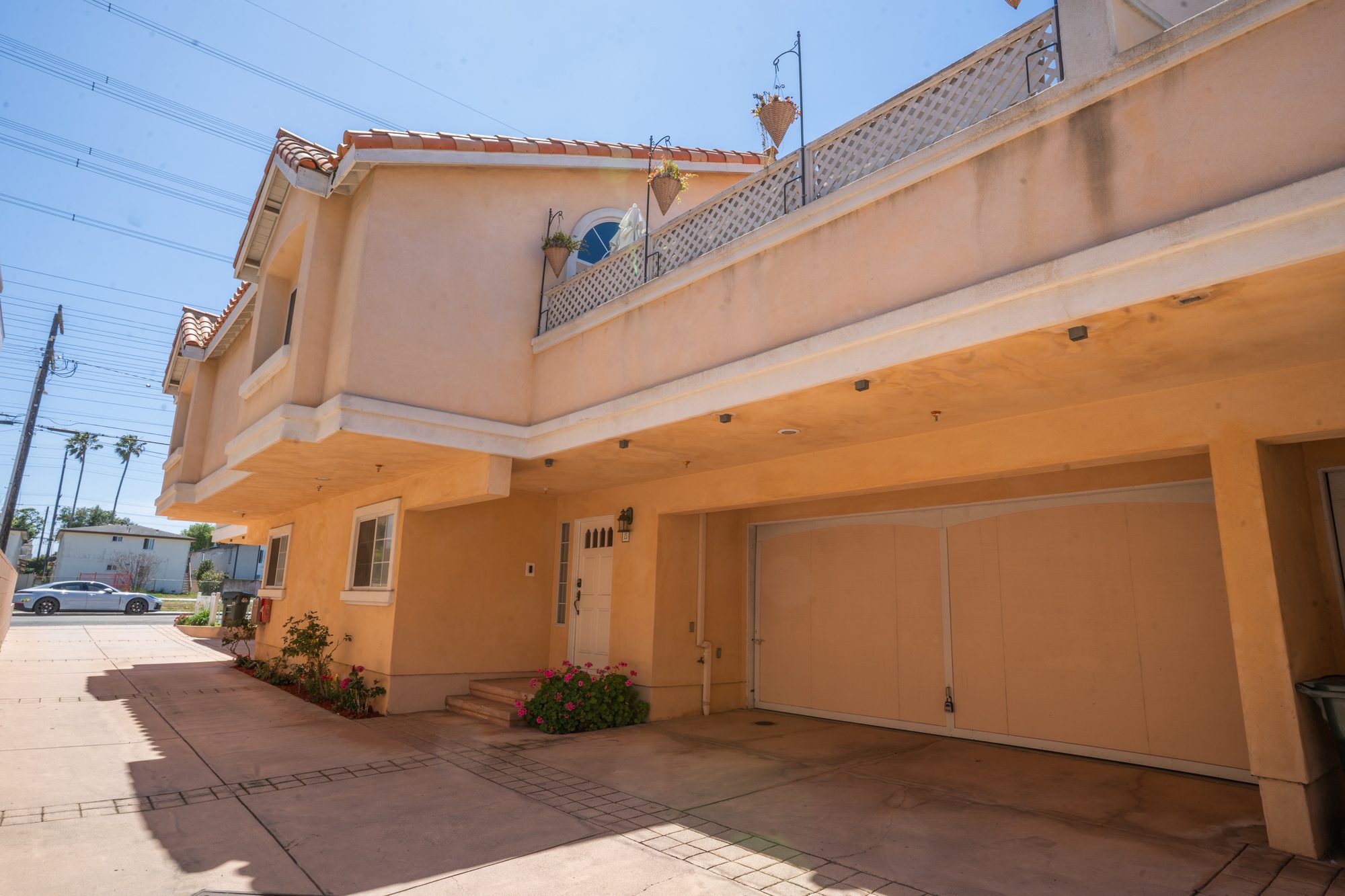 Driveway view of the attached two-car garage and entry